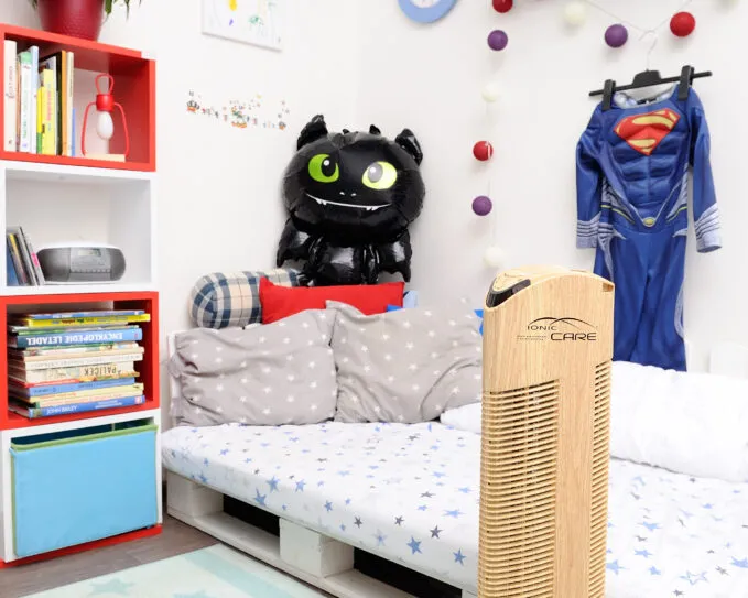 Čistička vzduchu Ionic-CARE v chlapeckém dětském pokoji s paletovou postelí, dekor dřevo dub